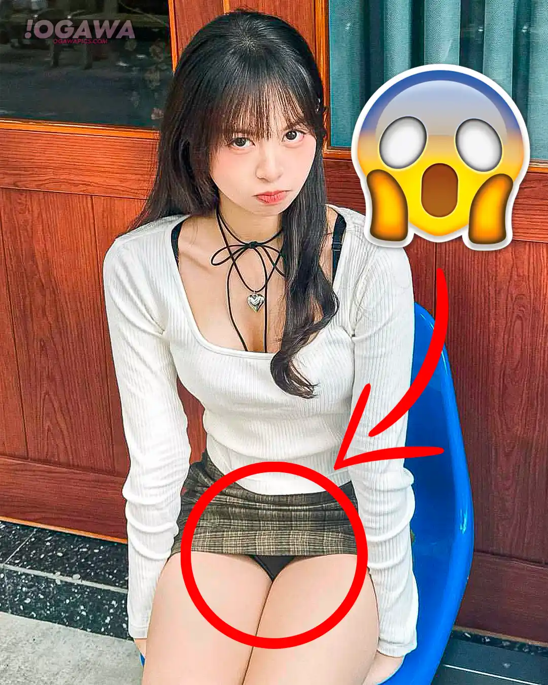 Beautiful Asian girl in skirt showing some panties while keeping a cute and angry face.